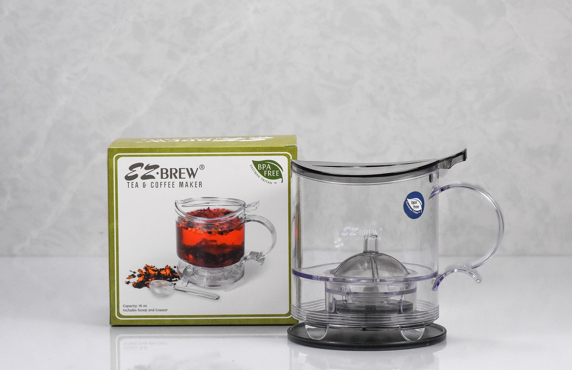 Clear EZ Brew tea and coffee maker with a box labeled 'Brew' on a light gray background