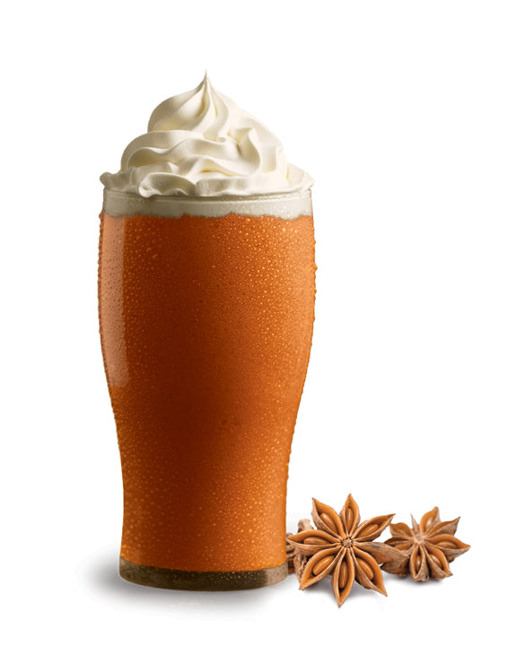 A glass of Thai Iced Tea with whipped cream on top, alongside two star anise spices.